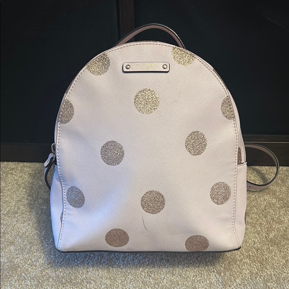 Stylish Pink and Gold Backpack with Rounded Shape and Smooth Surface